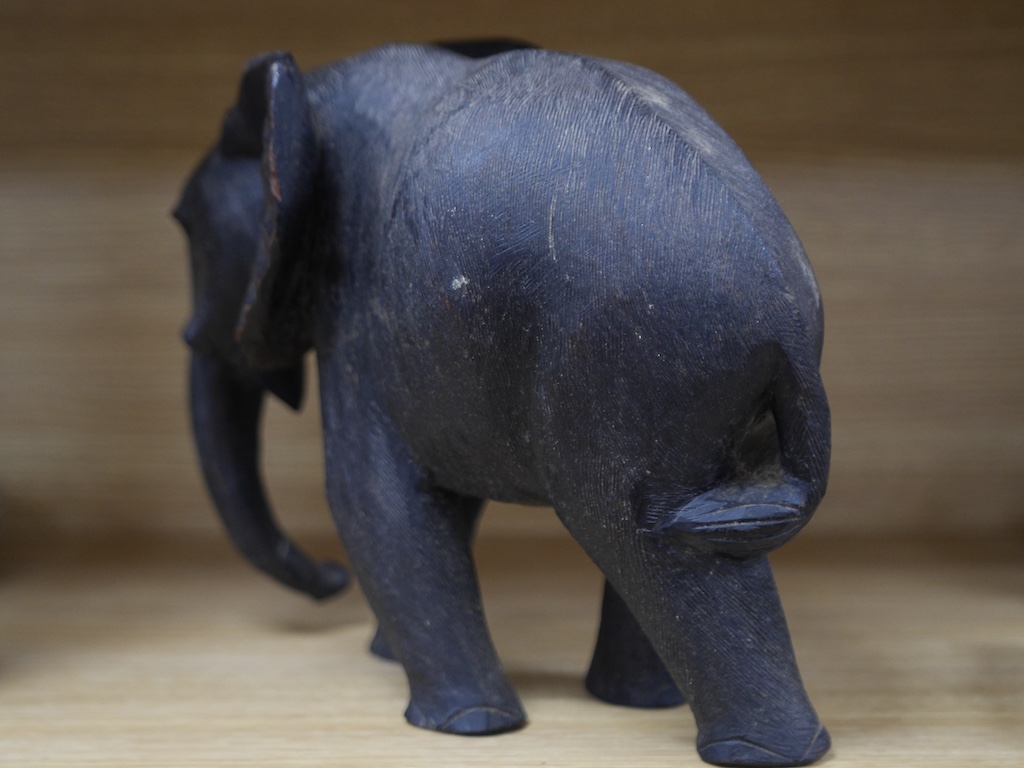 An African carved wood elephant, 27cm high. Condition - repaired section and tusks removed